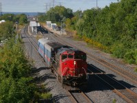 CN O480, the T.E.S.T train eases up to a red signal at Burlington East to wait on the westbound GO train, before proceeding east to Union Station.  CN 393 can be seen rolling through Burlington West in the background
