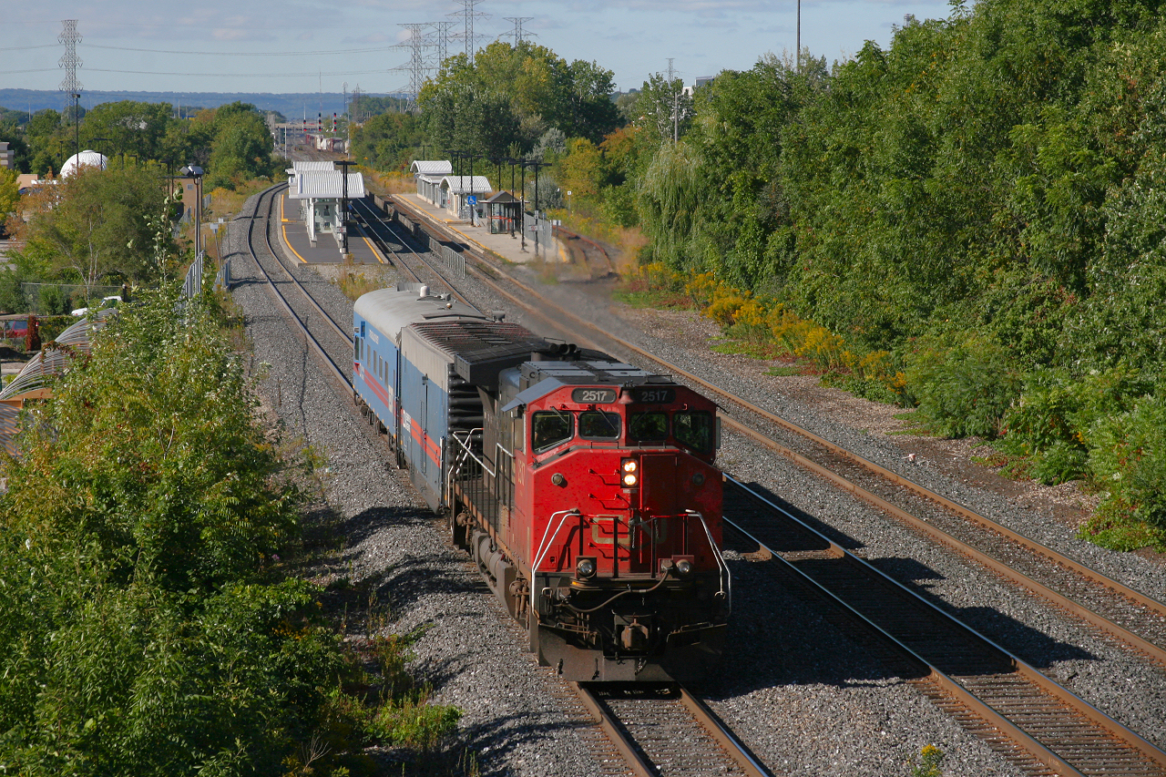 CN O480, the T.E.S.T train eases up to a red signal at Burlington East to wait on the westbound GO train, before proceeding east to Union Station.  CN 393 can be seen rolling through Burlington West in the background