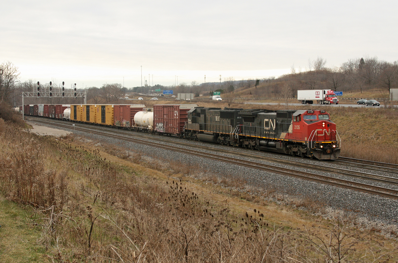 On a dreary Christmas Eve CN 2135 and IC 1021 scream through Snake after sitting at Bayview for close to 45 minutes waiting on VIA 97 and CN 421.