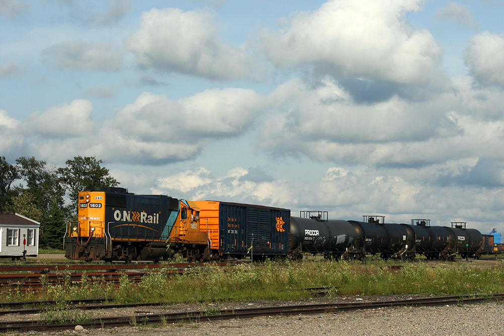 GP9 1602 sorting cars in Cochrane yard on a warm summer afternoon.