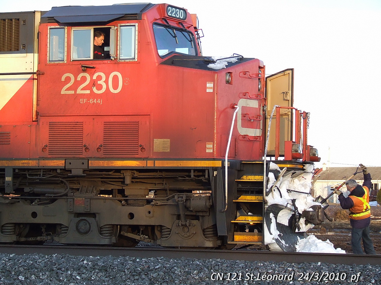 CN 121 meets a few train and in the meantime the conductor removes some NB snow.