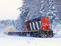 CN 595 hits the big curve at Utterson heading south on one of its twice-weekly jaunts down to Washago/Longford Mills, the day after a bit of a snowfall took away the "blah" from the landscape. 