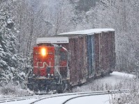 After bringing empty 4 boxcars down from Huntsville 595 had dropped them on the back track and gone up the spur to retrieve 2 loaded ones that were waiting at the Panolam plant. They pulled the loads down and coupled to the empties and are seen here shoving all six back up the hill to spot the empties at the plant. Afterwards they would bring the 2 loads back down to the back track (not visible here due to its lower elevation) and run around on the siding to grab them from the other end and haul them back to Huntsville. At huntsville Yard the loads would be set aside, along with whatever might be waiting there from Thursday's Longford Mills run, for the next 450 to lift on its way south from North Bay to Mac Yard. 