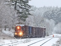 After bringing empty 4 boxcars down from Huntsville 595 had dropped them on the back track and gone up the spur to retrieve 2 loaded ones that were waiting at the Panolam plant. They pulled the loads down and coupled to the empties and are now preparing to shove all six back up the hill to spot the empties at the plant. Afterwards they would bring the 2 loads back down to the back track (not visible here due to its lower elevation) and run around on the siding to grab them from the other end and haul them back to Huntsville. At huntsville Yard the loads would be set aside, along with whatever might be waiting there from Thursday's Longford Mills run, for the next 450 to lift on its way south from North Bay to Mac Yard.