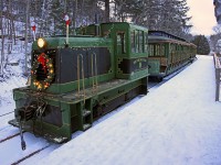 After bringing volunteers and supplies to Fairy Lake Station, the Portage Flyer Christmas Train waits while the station and platform are decorated for the evening's Santa runs.