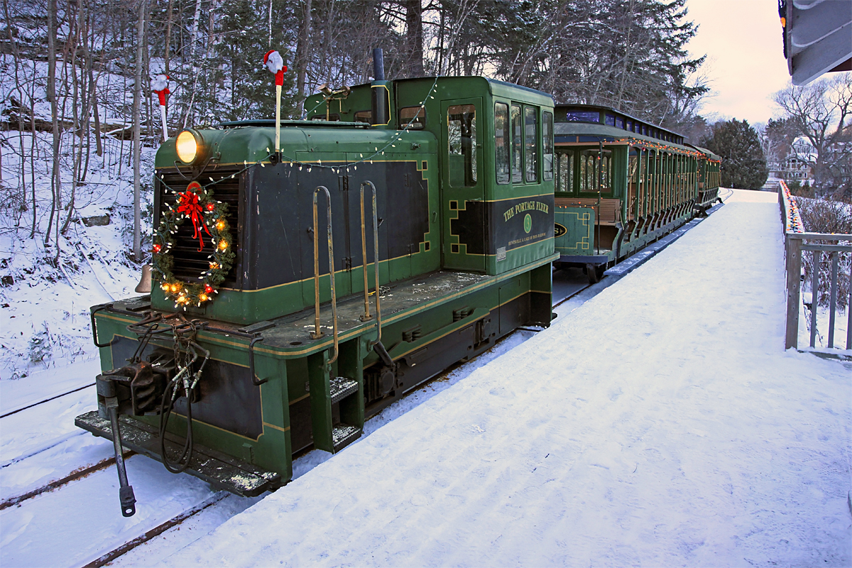 After bringing volunteers and supplies to Fairy Lake Station, the Portage Flyer Christmas Train waits while the station and platform are decorated for the evening's Santa runs.