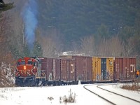A worn-down snowman watches silently as 4132 shoves a cut of cars it had just brought down the spur from the Panolam plant up the back track at Martins in preparation for running around them to make the haul back to Huntsville on this last day of 2012.