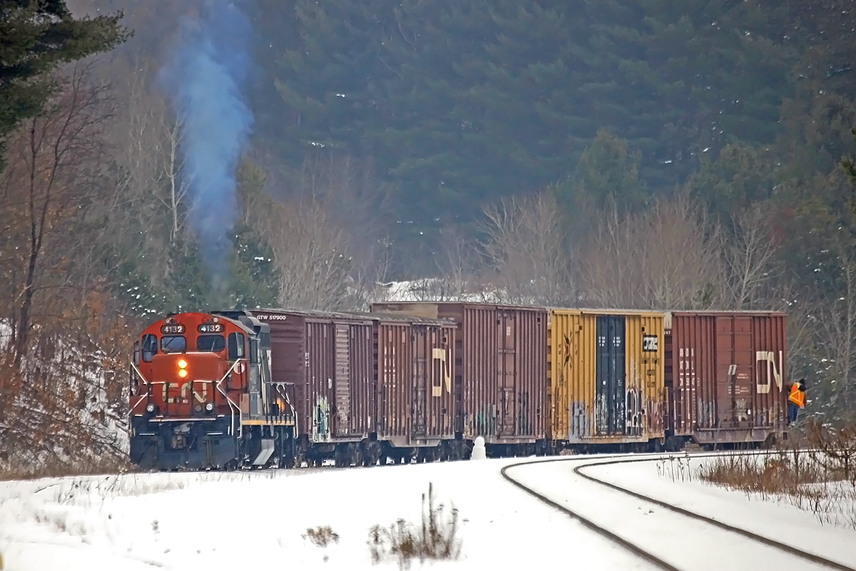 A worn-down snowman watches silently as 4132 shoves a cut of cars it had just brought down the spur from the Panolam plant up the back track at Martins in preparation for running around them to make the haul back to Huntsville on this last day of 2012.