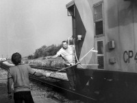 The Conductor on CP Rail train #955 (CP Rail 8600 North) prepares to take train orders on the fly at Bolton, Ontario. August 1978 negative by S. Danko.