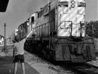The Hogger on CP Rail train #955 (CP Rail 8600 North) prepares to grab the train orders on the fly at Bolton, Ontario. (8600 may well have been the last MLW RS-10s delivered to the CPR, in any event all RS-10s were retired by 1984). August 1978 negative by S. Danko.