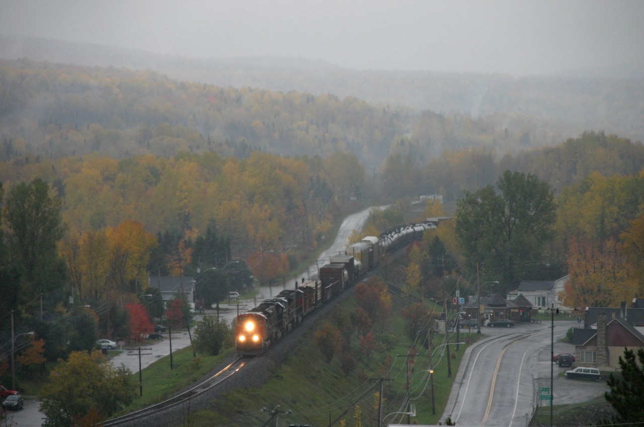 The 308 with 2 CN , 1 IC and 1 BC Rail engine on way to Moncton NB in Estcourt part of Pohénégamook . Just note , the train's right side , you're on the United States territory and the train's left side , you're on the Canadian territory . The pictures was taken on the Canadian side during a rainy morning !
