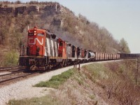 CN 4585, 4516, 4563, 4560, a quartet of GP9s, powers a westward train up the long grade to Copetown under the watchful Dundas Peak on a beautiful spring day 35 years ago.