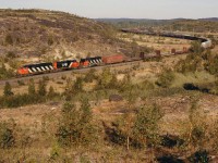 CN 5404 leading the the #336 has just crossed the CP diamond and is about to head south on the Bala Sub at Coniston, ONT.   9/17/2002

If you notice, the cab of the third unit was gotten an oil bath from the second unit with a massive oil leak...