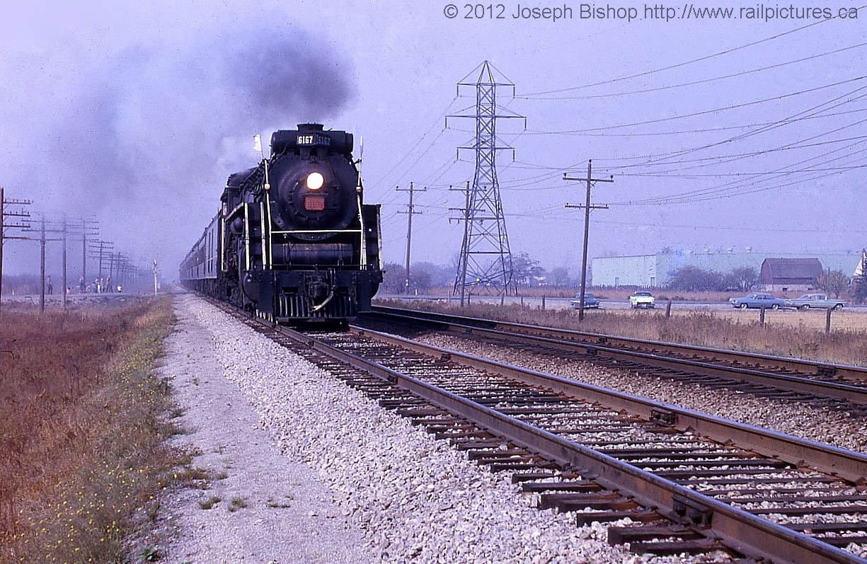 CN 6167 leads an excursion across the CN Grimsby Subdivision just outside of Grimsby Ontario.  6167 lead a several excursions in October of 1963.  My Great Grandfather was one of many who came out to photograph the train as it passed.  This photo is added with permission and was taken by my Great Grandfather Charles Bishop.