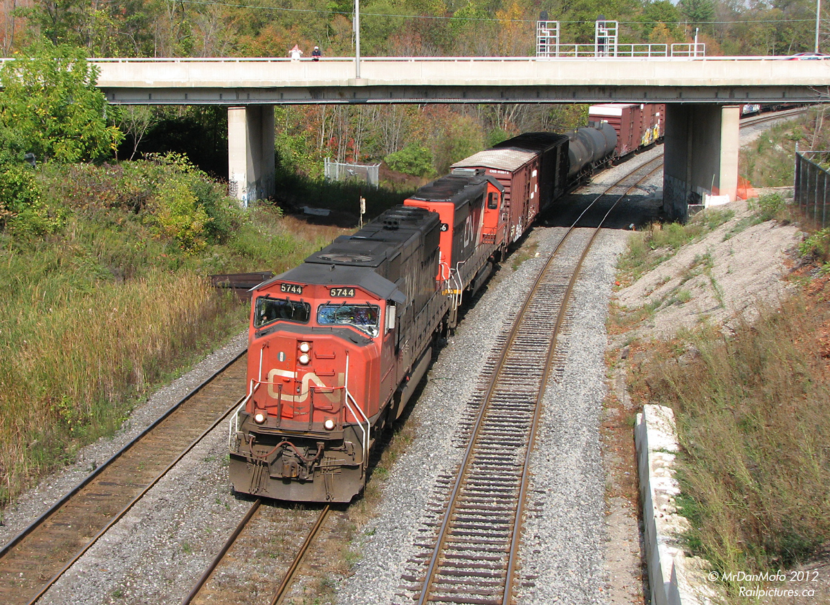 It's not a passenger train drawn by an FPA4, or a hotshot with 4 CN GP9's, but the standard-issue modern Bayview freight of the 21st century. Westbound on train 435, CN SD75i 5744 and IC SD40-2 6256 round the bend and make a run for the hill at Bayview Junction, from the usual foamer vantage point of the Royal Botanical Gardens bridge. While a few changes have occurred in the area, including triple tracking, modern signals and CTC, at Bayview a train is still a train, and the cameras present make their usual noises as it passes by.