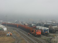 The CN railtrain rests at Hamilton as the Railink crew work around them.