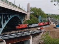 Southbound CP train headed for Kinnear Yd passes Desjardins (the CN Oakville connction)as well as the construction for anticipated GO Transit traffic of the future. CP 1832, HLCX 663, CP 4215 and 4207; train number not recorded.
The lead unit was off the roster by 1998, the leased unit returned and the two C-424s retired in 1996.
This view at the High level Bridge off York Blvd is somewhat marred now by lightposts and other fixtures, as a public footpath was constructed under the bridge a few years back.