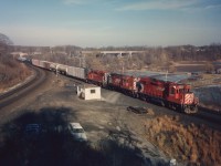 The "Starlite" was getting on in life by the end of the 1980s, as by the time this photo was imaged, any power available was good enough. CP 3027, 8781, and 3102 are Hamilton-bound thru Bayview Junction in a very late day scene, the setting sun is right in the crew's faces as they roll past.
The 8700 would be rebuilt into the 1800 series by years' send.
Photo shot with Speed Graphic using 4x5 sheet film. Digital shooters have no idea how easy they have it!!!