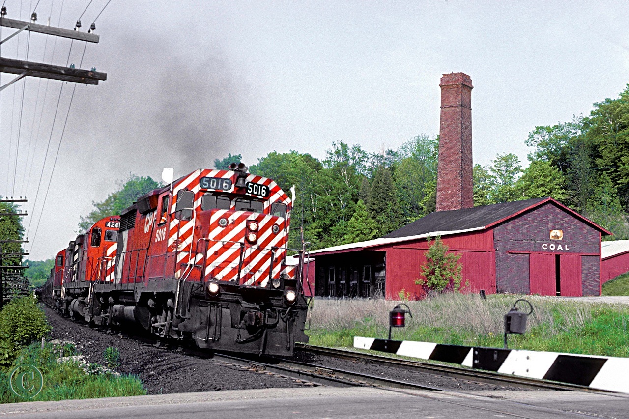CP 5016 with sulphuric acid train 937 and trailing units 4221 and 4226 lean into the curve at mile 38 on the CP's Galt Sub.