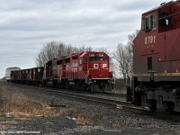 Performing a rolling meet, CP trains T25 and 112 pass at Lovekin. T25 behind CP 3126 and 4657 will stop to work the backtrack, picking up two rail flats which will join the already awelled consist of five ballast hoppers from the Newtonville pocket track and what looks to be a revenue car out of Cobourg.CP 8791 and 8567 power 112. 1453hrs.