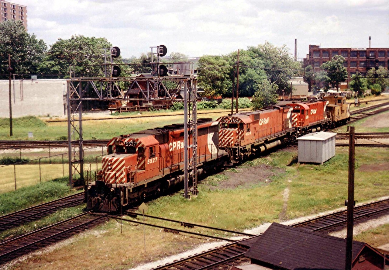 Thru the maze that was West Toronto Junction is CP 5527, 4724, 4203, a "caboose hop" heading over to Lambton to pick up a train.
Photo taken from the old Weston Rd bridge. Train is crossing the CN Weston sub and the CP MacTier sub. as it leaves North Toronto Sub and enters the Galt sub.
The original Toronto, Grey & Bruce trackage was between the CN/CP and the N.T.O. connector (to MacTier sub) at upper left.
Track in lower foreground is the Galt sub trackage.
Trackcar 'shanty' in foreground.
Confusing or what?
No longer. This whole junction has been completely gutted and rebuilt for new highspeed commuter service between downtown and the Airport.
Hope I got this right!!  Open to corrections.