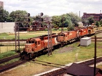 Thru the maze that was West Toronto Junction is CP 5527, 4724, 4203, a "caboose hop" heading over to Lambton to pick up a train.
Photo taken from the old Weston Rd bridge. Train is crossing the CN Weston sub and the CP MacTier sub. as it leaves North Toronto Sub and enters the Galt sub.
The original Toronto, Grey & Bruce trackage was between the CN/CP and the N.T.O. connector (to MacTier sub) at upper left.
Track in lower foreground is the Galt sub trackage.
Trackcar 'shanty' in foreground.
Confusing or what?
No longer. This whole junction has been completely gutted and rebuilt for new highspeed commuter service between downtown and the Airport.
Hope I got this right!!  Open to corrections.