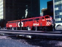 The power off the Eastbound "Canadian"#2 gets a cleaning and a scrubbing during layover in downtown Calgary on September 28, 1978. There is just over a month of independence left, at the end of October this CP train would be incorportated into the newly formed VIA system.  Power is 1404 and 1416.