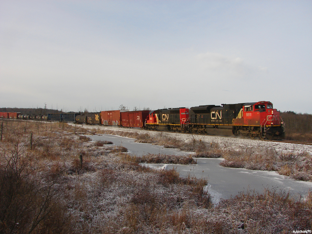 CN 451 - CN 8811 North highball's out of Falkenburg after making the hill, kicking up some fresh snow on the way!