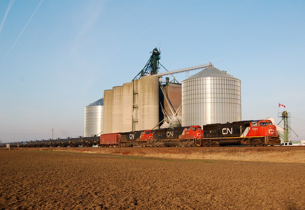 CN U700 unit oil train gets moving past the elevator at Wanstead, Ontario.