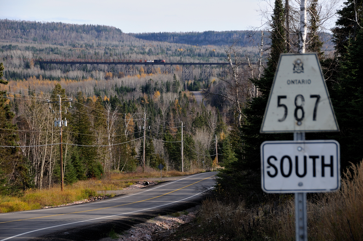 October 22, 2008. The first "official" day of the official beginning of the end for the CN Kinghorn Subdivision. Mostly secluded north of Nipigon the line hosted two trains a day (M336/M337)until 2005 when the service was abolished. Ever since that day in 2005 the pair of rails and steel structure that supports them at mileage 173 sat dormant and rusting.  Fast forward three and a half years later, the work train that has been ordered to remove the rail of the sub slowly creeps backwards across the decrepit structure. Destined for mileage 153 where the Thunder Bay crew will begin tearing up "the western portion" of the line. There will only be a handful of trains left to use the old bridge which has been standing since 1916.... On December 8, 2008 the last string of rail was loaded east of the bridge and the CN departed Pass Lake for the final time.