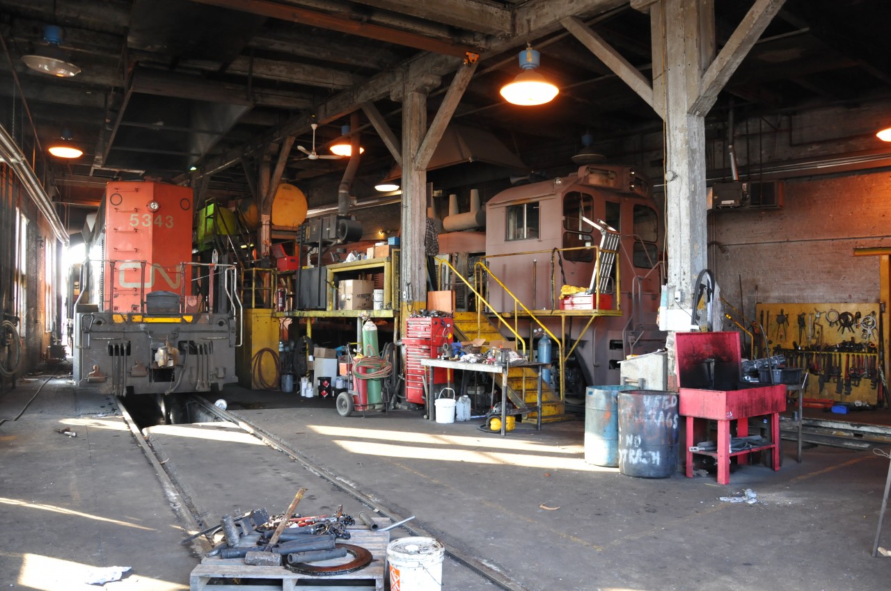 CN 5343 and LDSX 1359 sit inside the LDS round house today. CN 5343 is in for a replacement cab after an accident with a coal chute out west and LDS 1359 is in for paint, renumbering after being completely bead blasted and primered.