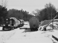 <i>Barrie Collingwood Railway chase 3 of 7.</i> Enroute to Collingwood the westbound freight rolls past the only other "major" customer on the line between Utopia and Collingwood; F.S. Partners in Stayner, who provides agronomy services. After spotting Canadian Mist distillers (tank cars) in Collingwood the freight would return with the single hopper for Stayner, pulling three cars and spotting the one.