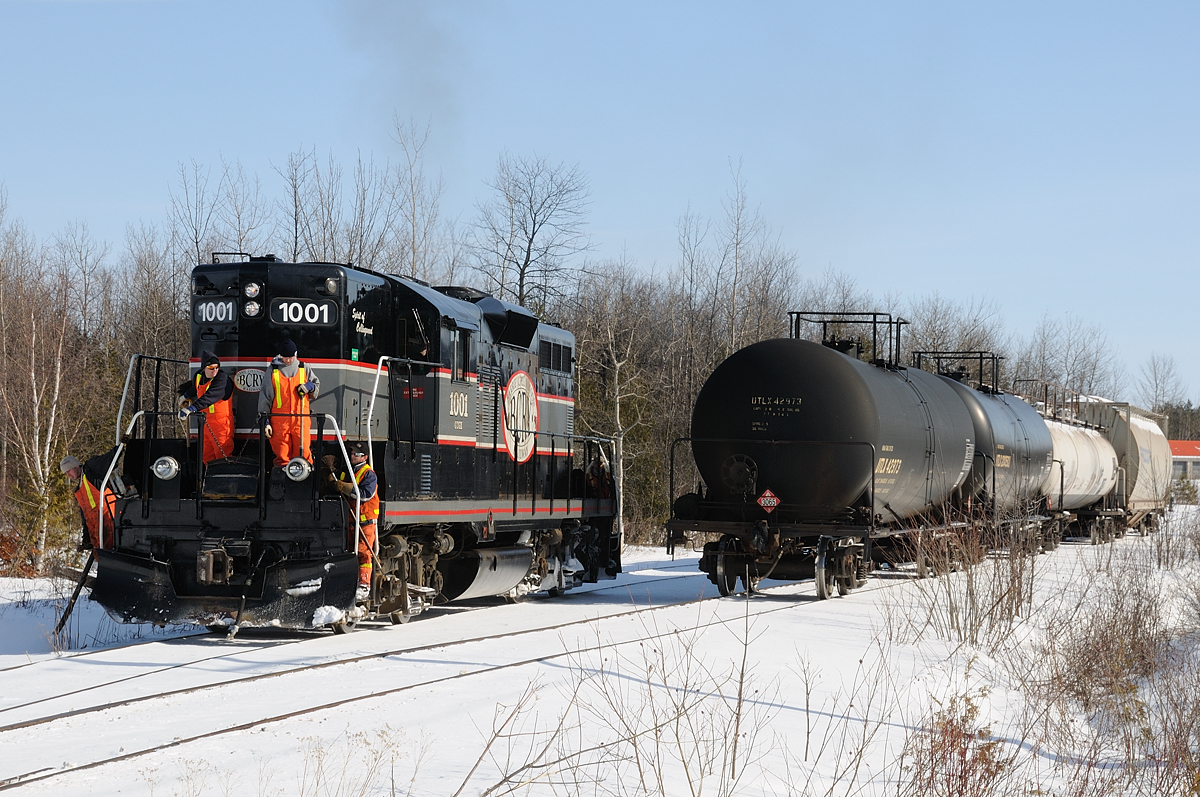 Barrie Collingwood Railway chase 4 of 7. Upon arrival in Collingwood, the "ES" (maintainence) crew that has been following the train since Utopia jumped on the engine at the last public crossing on the line (Raglan Street) in Collingwood. The switch crew pulled their train onto the short run around track, the ES crew cleared the switch at the end of track of the snow so the conductor could line the switch, everyone boarded the engine for the run around move before stopping to clear the other switch of the snow and ice that had built up since the last time the train had visited Collingwood.