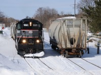 <i>Barrie Collingwood Railway chase 6 of 7.</i>After a bite to eat at Canadian Mist, the crew have began their return to trip to Utopia. They had a stop at F.S. Partners in downtown Stayner to pull 3 empties and spot 1 load. The crew would leave their one load on the "main" as they 'nosed' into grab the three empties. The crew grabbed the one load on the main and spotted it. One things that I found really interesting of this branchline (/spur) were the old wooden whistle posts. Most sported the metal sign on them although they all originally had a 'W' engraved in the wood. Good ol' classic branchline characteristics that will disappear with the abandonment of this light rail line.