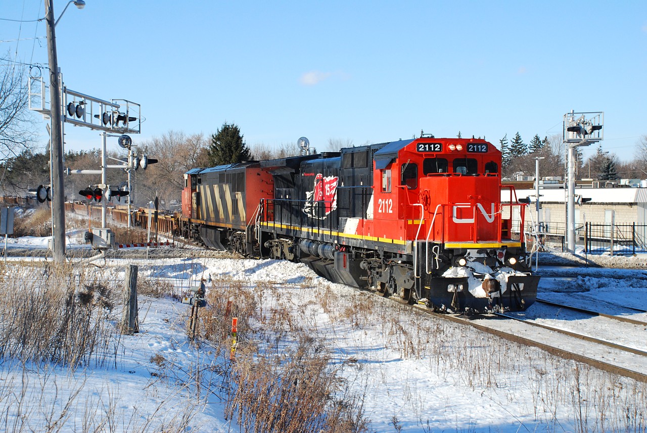 CN 148 cruises in to Brantford the day after a heavy snow storm that caused a lot of "missed connections" in Chicago, as illustrated by all the empty well cars at the head end of the train.
