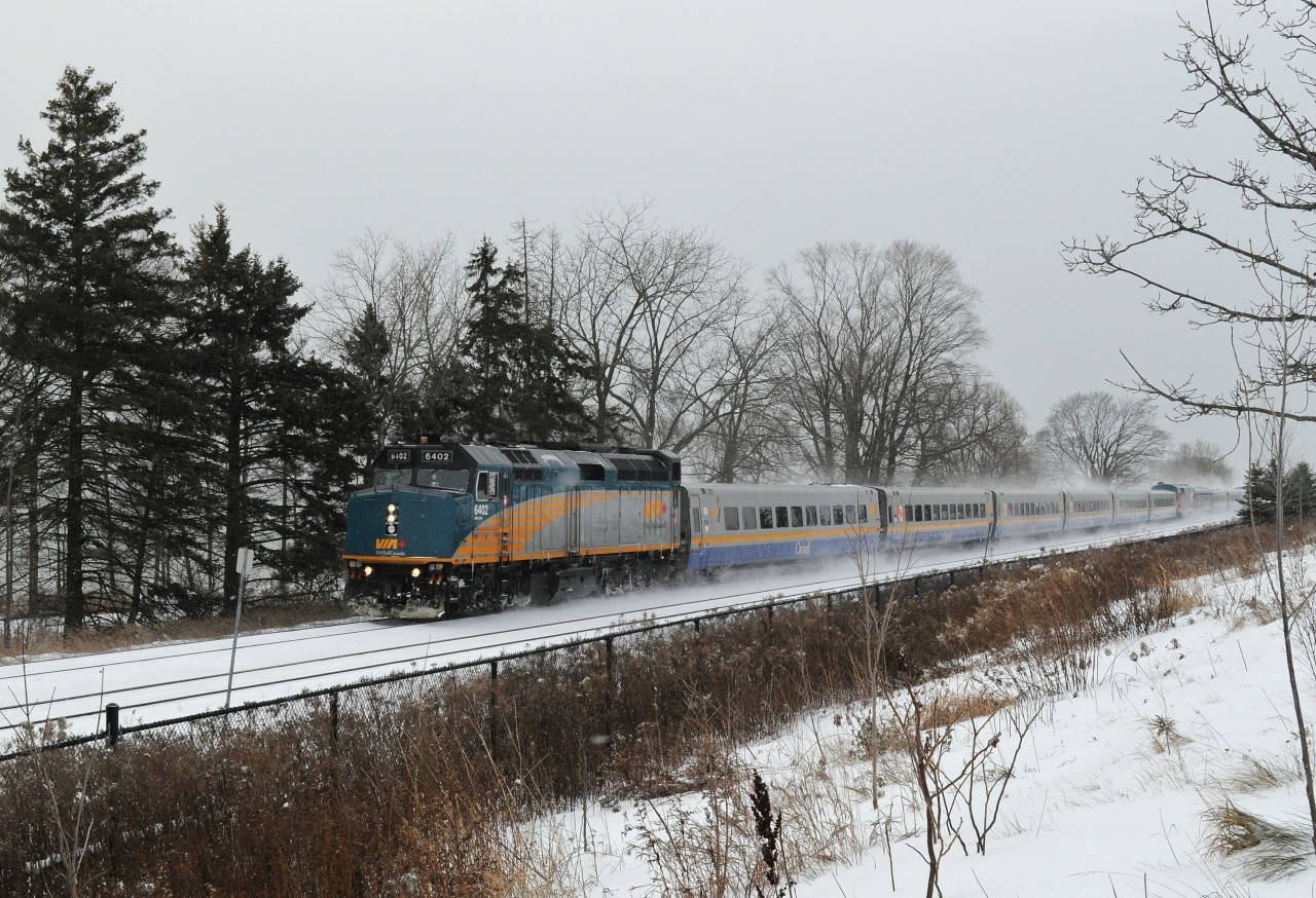 After two snow-less winters, finally a significant snow in the Carolinian Rouge Hill forest. Via J train #56 – 54 (6402 – 903 ) zips through CN Rouge Hill. Via #54 (Ottawa bound) has interesting mix of conventional / LRC equipment, that is conventional SS coach 4109 on the tail end. December 27, 2012 image by S.Danko.
