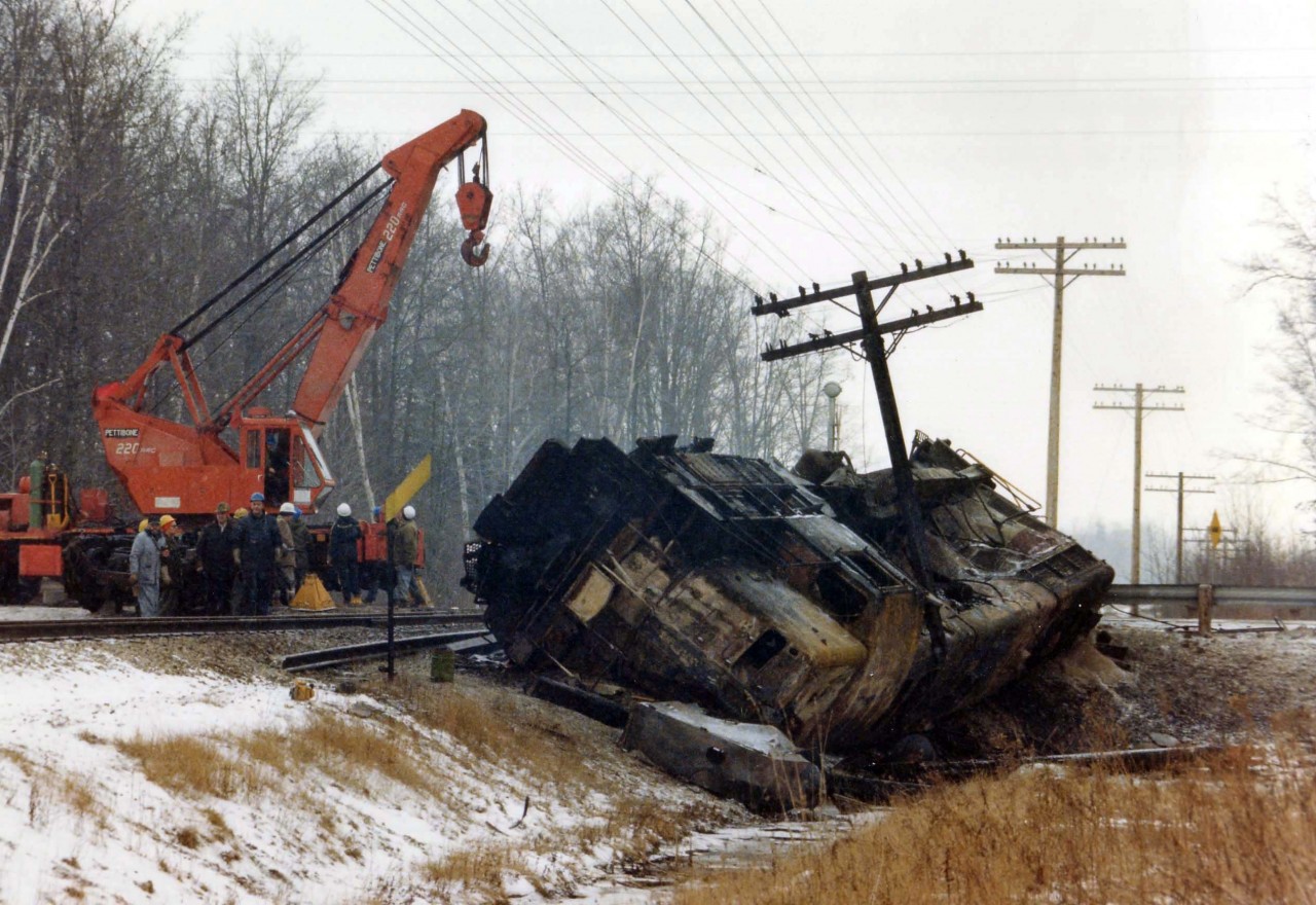 The first locomotive ever built by GMD in London after the locomotive division came into existence in 1950 was TH&B's GP 7  #71, and it met an untimely fate at Webber Rd, a few miles west of Welland on Feb. 12, 1980. A loaded semi failed to stop and broadsided the locomotive, knocking it into the ditch. Fuel spills resulted in both the truck and locomotive catching fire. The railroad crew survived but the truck driver perished.
This view is from the following morning, as a heavy crane positions itself to assist in the attempt to bring #71 back onto its feet; and later it was taken to Hamilton........and eventually the scrapper.
