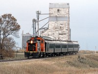 To celebrate the restoration of the former Northern Pacific of Manitoba, a CN predecessor, station at Miami Manitoba the historic society ran a weekend of excursions out of Miami on Southern Manitoba Railways former CN line in Southern Manitoba. CN SW1200RS on a Somerset turn with Prairie Dog Central coaches passes the elevator at Deerwood after climbing the Pembina Ridge on a massive loop.