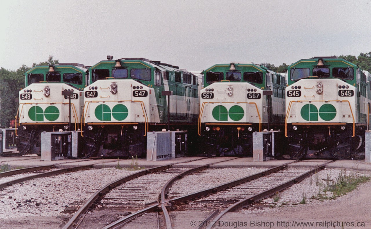 GOT 548, 547, 567 and 545 sit at Guelph Junction awaiting their next assignments.  This photo is no longer possible because GO no longer uses Guelph to park their trainsets.  Photo by Douglas Bishop added with permission of the author.