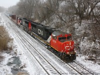 <Oh the weather outside was frightful!/b>  

This photo was taken almost a year ago at Copetown Ontario on the CN Dundas Subdivision.  It was 3 degrees fahrenheit outside and I was cold!  A little bit of snow had fallen the day before and as CN 148's headlight came into view down the line more snow had began to fall.  The flurry didn't last long, but it was enough for 148 to kick it up a little bit.  

Hopefully this winter proves to be a true Canadian winter, because nothing compares to a train in snow.