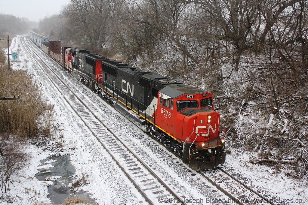 This photo was taken almost a year ago at Copetown Ontario on the CN Dundas Subdivision.  It was 3 degrees fahrenheit outside and I was cold!  A little bit of snow had fallen the day before and as CN 148's headlight came into view down the line more snow had began to fall.  The flurry didn't last long, but it was enough for 148 to kick it up a little bit.  

Hopefully this winter proves to be a true Canadian winter, because nothing compares to a train in snow.