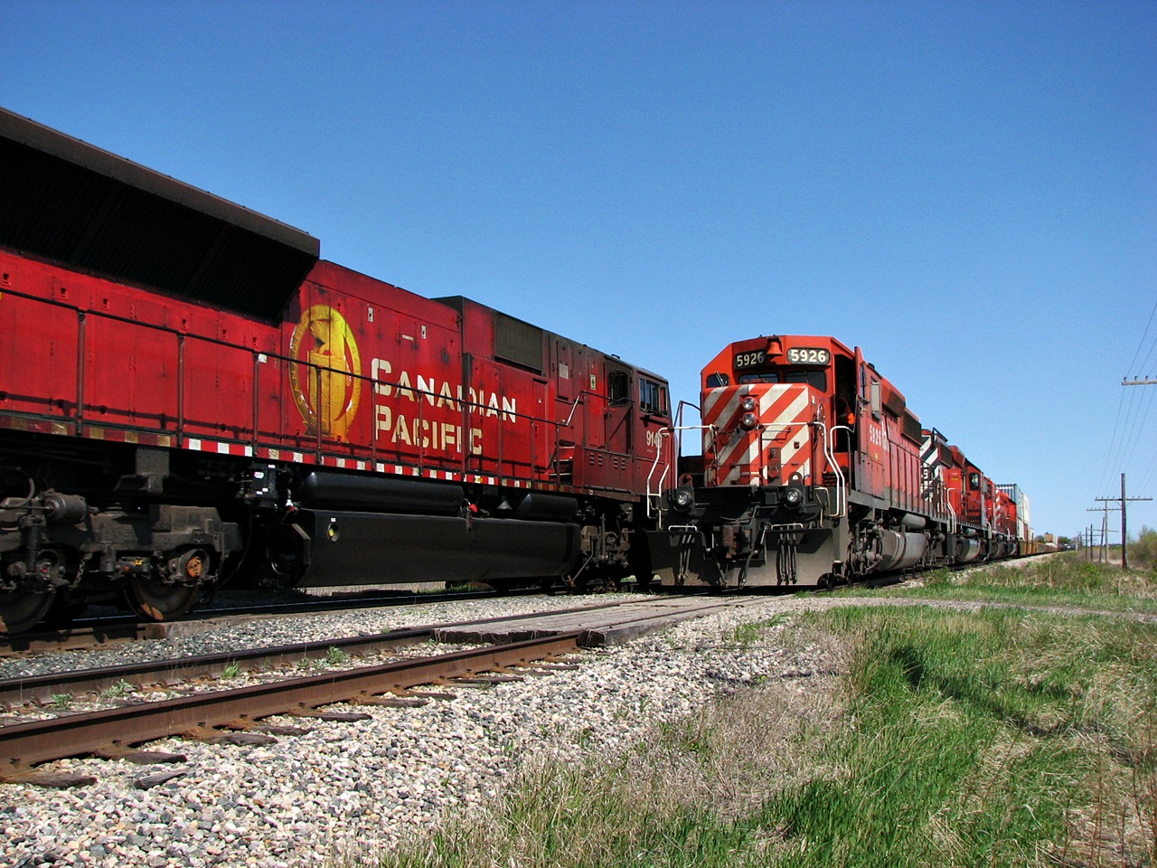 EMD's big and small pass each other at Rotave siding on the CP Broadview Subdivision. While the big mac's have since been put on the market the remaining SD40-2's continue to soldier on.
