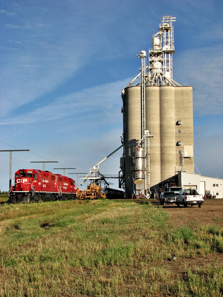 CP GP38-2's wait for a work block to go lift CWR between Moosomin and Broadview Saskatchewan as they sit parked at the P&H elevator west of Moosomin Sk.
