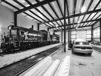 Sitting inside Ontario Southland Railway's Salford, Ontario shops are OSR's new acquisitions, former CP Rail SW1200RS's, among the regular MLW fleet along with employee vehicles.
