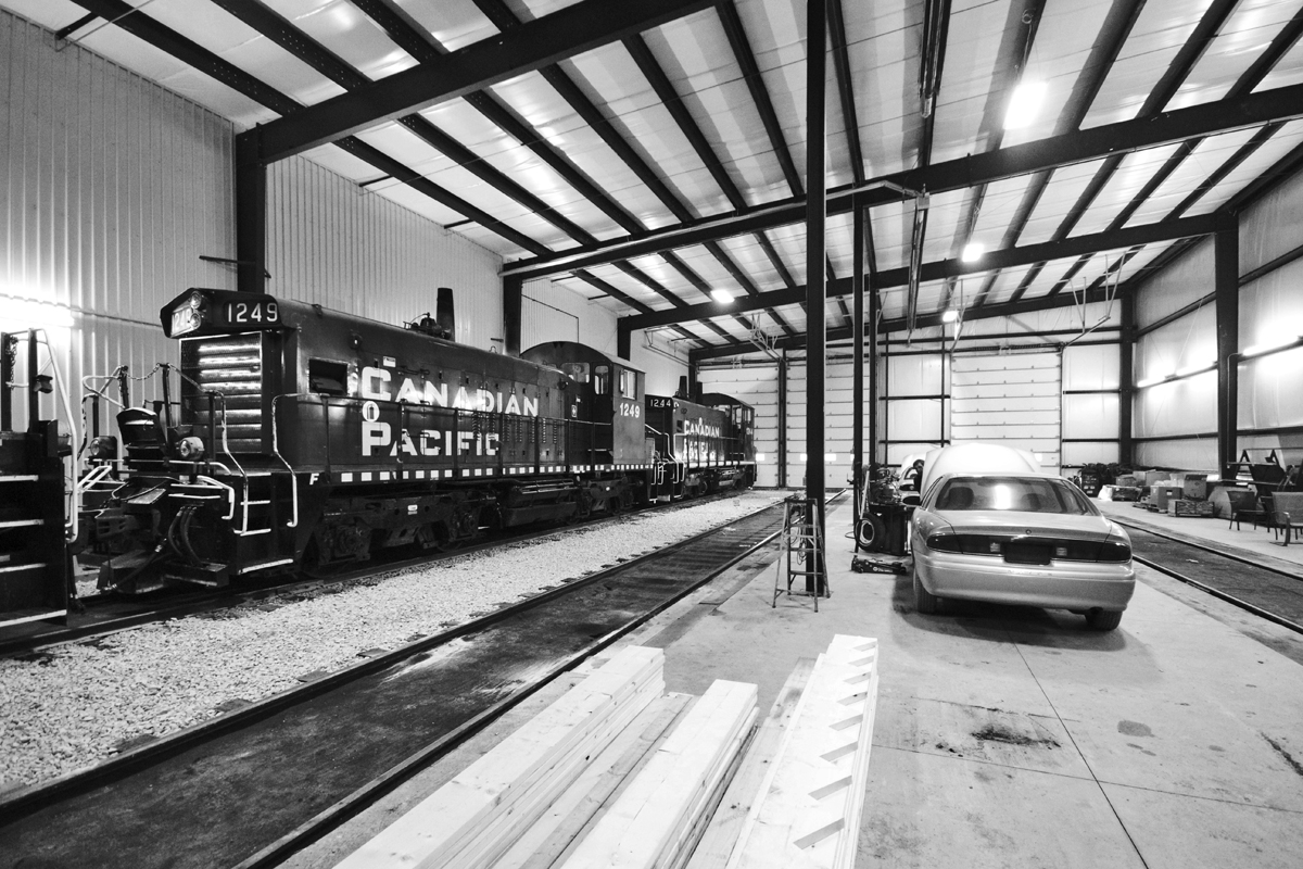 Sitting inside Ontario Southland Railway's Salford, Ontario shops are OSR's new acquisitions, former CP Rail SW1200RS's, among the regular MLW fleet along with employee vehicles.