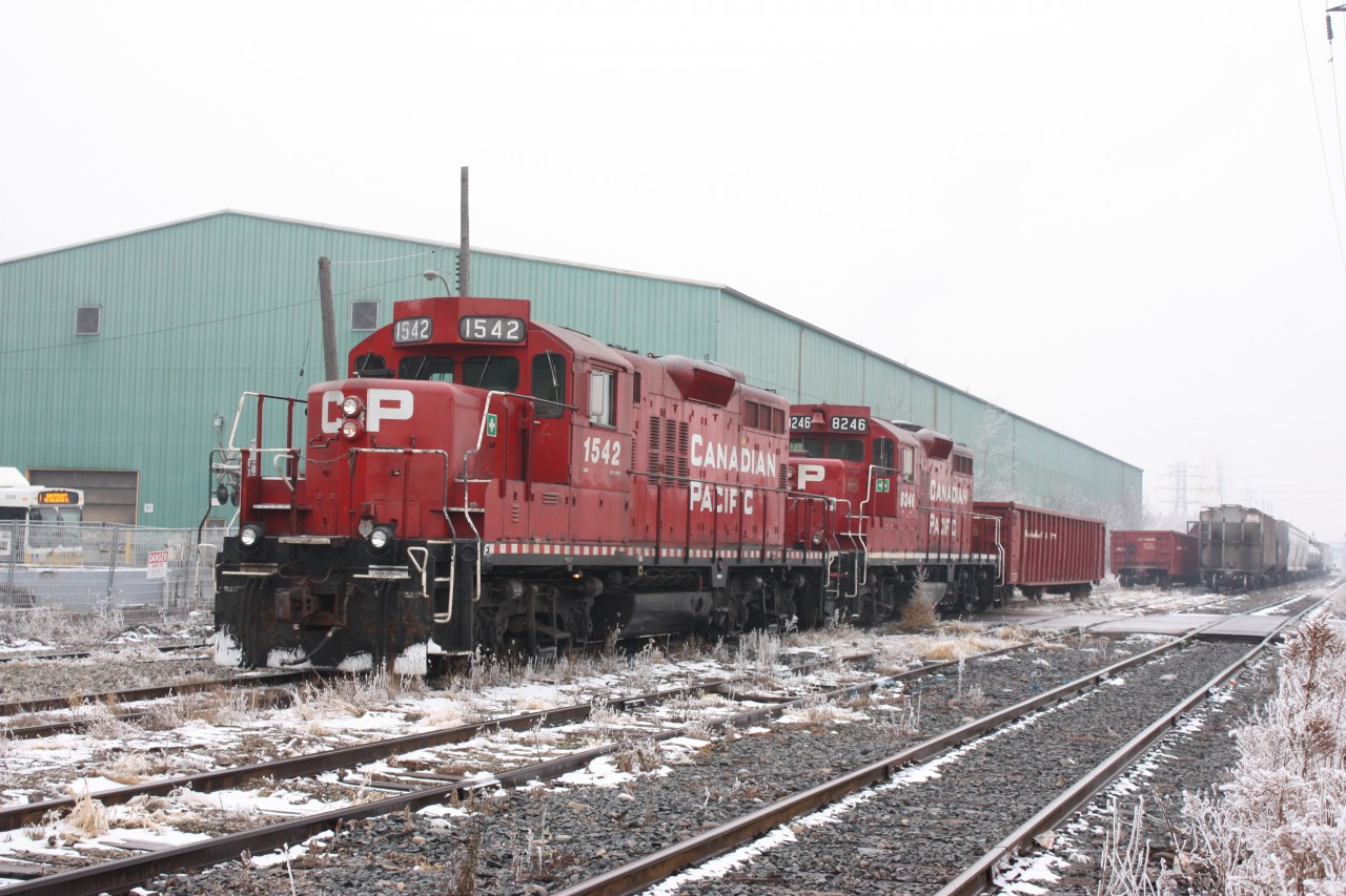 CP's Belt LIne job with a pair of GP9Us works cars along side SOR's former CN H&NW spur deep in Hamiltons industrial section.