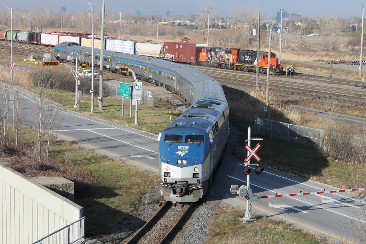 Amtrak loco 43 P 42 DC pulling via stanless cars on rt 68 to New York spécial occasion Amtrak having many cars damaged plus New Jersey Transit because of Sandy  hurricane so Amtrak help NJTransit and Via pass cars to Amtrak for a few weeks photos taken from passerelle between Longueil and St-Hubert you could see in Southwark CN yard loco  CN-4809 GP-38 2 W and loco CN-7275 GP-9 RM working in the yard