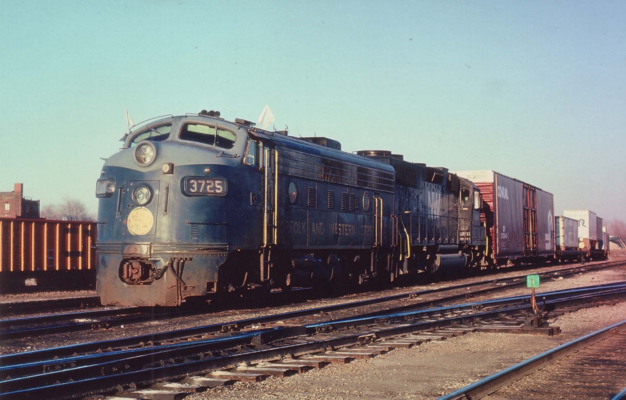 With traffic brought over mainly from the Erie-Lackawanna, N&W 3725 and 4142 are about ready to head west to Detroit with the evening ND-91 (New York-Detroit). This train was difficult to photograph as it usually left at the close of daylight and I was rarely able to get decent light on it more than 5 miles west of here. Morning counterpart DN-90 usually arrived at Fort Erie in the wee hours and I never did catch that one. Train is seen in front of the CN Yard Office. The once hectic yard is now mostly empty save for minor transfer work and the Fort Erie Museum setting up shop in the old CN repair facility.