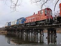 Latest acquisitions for the OSR cross the Eramosa River in Guelph southbound to Guelph Jct.  Units were placed in the shop there and will be restored to running condition as traffic warrants.