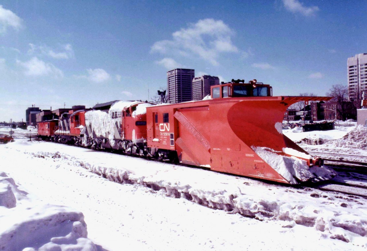 CN Plow Extra running in an eastward direction thru London back in March of 1978; Plow is #55614, power is CN 9179, 4530 and caboose 79874.  Winter is beginning to fade, the snow looks old with a new dusting to give the scene some freshness.  I am not exactly sure where this image was shot, I can only remember somewhere east of downtown; as the skyline has changed dramatically since. The F7Au was one of a series all retired by 1989. Assume it went for scrap.